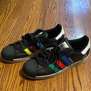 Adidas Men's Black “Inclusivity” Sneakers with Multicolor Stripes.